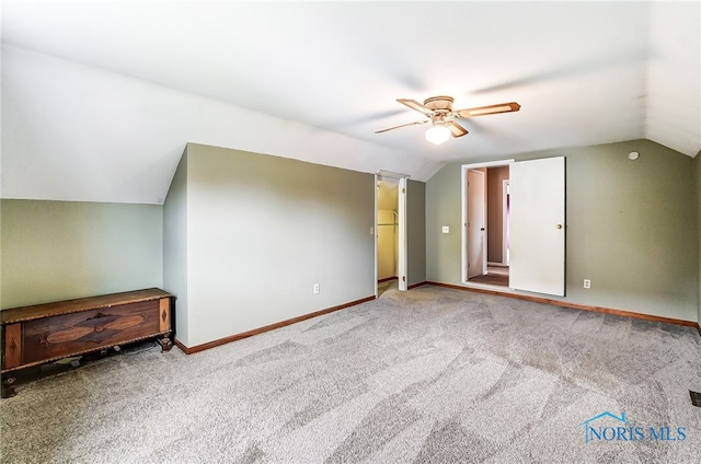 additional living space featuring carpet flooring, ceiling fan, and vaulted ceiling