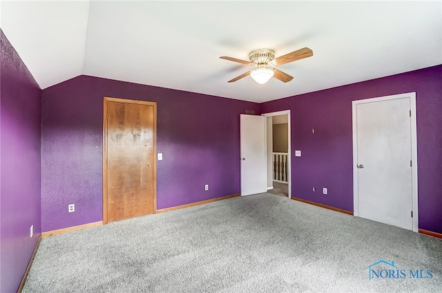 unfurnished bedroom with lofted ceiling, ceiling fan, and carpet floors