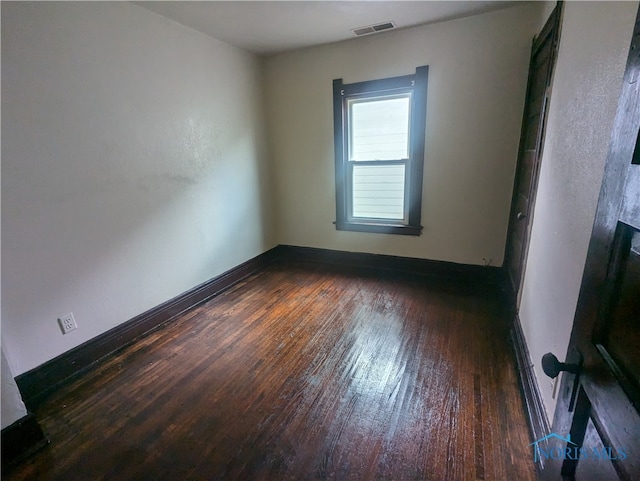 spare room featuring dark hardwood / wood-style floors