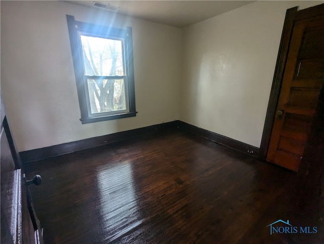 empty room featuring dark hardwood / wood-style floors