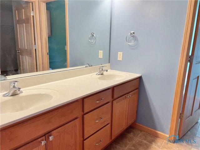 bathroom featuring tile patterned flooring and vanity