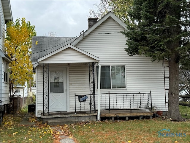 back of house with a lawn