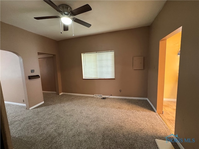 carpeted spare room with ceiling fan