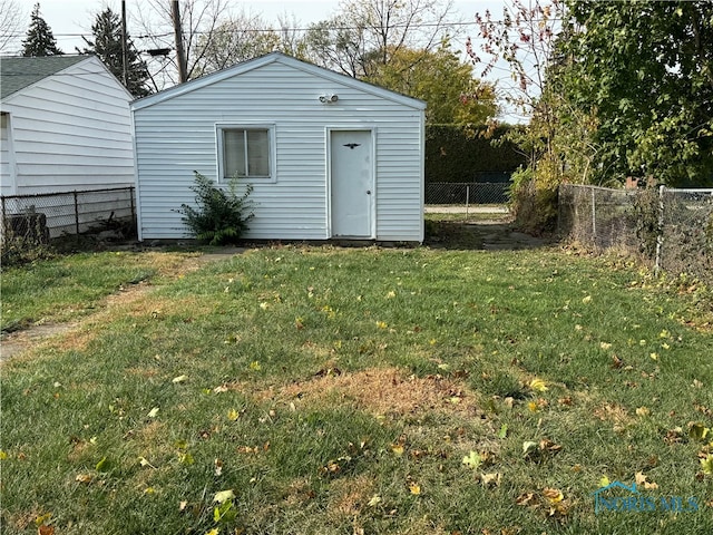 view of outbuilding with a yard