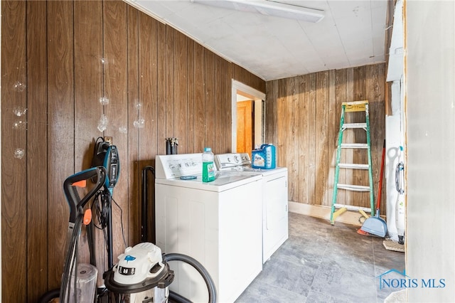 washroom with separate washer and dryer and wooden walls