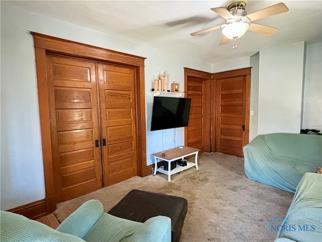 living room featuring ceiling fan and carpet floors