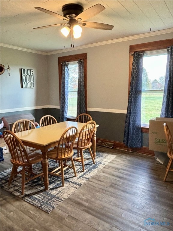 dining space featuring ceiling fan, hardwood / wood-style floors, and ornamental molding