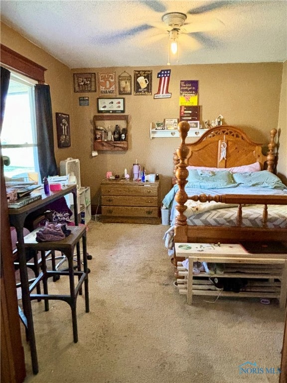 carpeted bedroom with ceiling fan and a textured ceiling