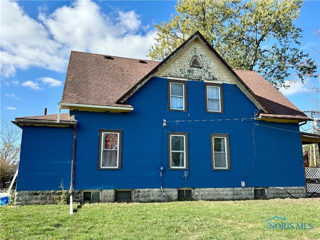 view of home's exterior with a lawn