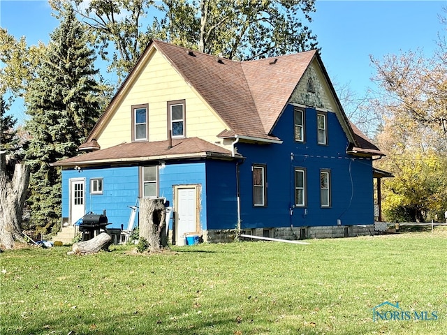 rear view of house with a lawn