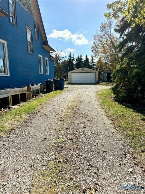 view of side of property with a garage and an outdoor structure