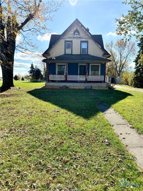 view of front of house with covered porch and a front lawn