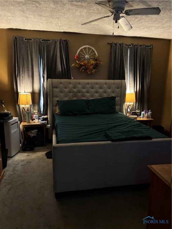 carpeted bedroom with a textured ceiling and ceiling fan