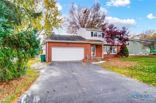 front facade with a garage and a front lawn