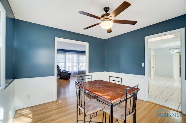 dining space featuring ceiling fan and light wood-type flooring