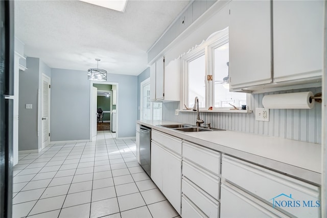 kitchen with white cabinets, light tile patterned floors, decorative light fixtures, and dishwasher