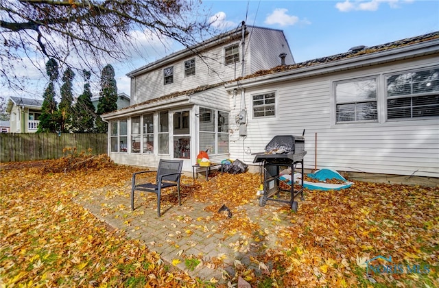 back of property featuring a patio area and a sunroom