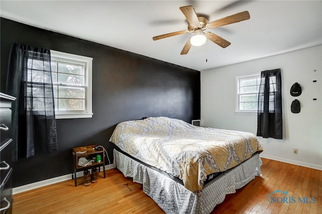 bedroom featuring hardwood / wood-style floors and ceiling fan