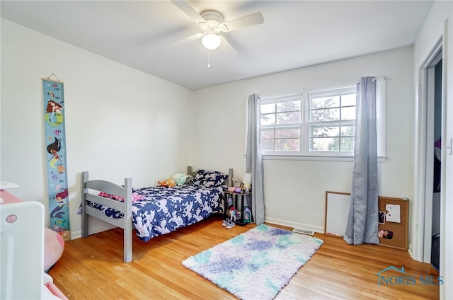 bedroom with hardwood / wood-style flooring and ceiling fan