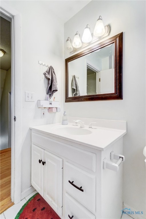 bathroom with vanity and hardwood / wood-style floors