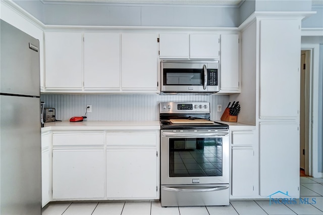 kitchen featuring white cabinetry, light tile patterned flooring, and stainless steel appliances