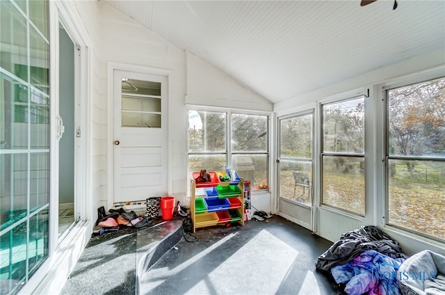 sunroom featuring ceiling fan and vaulted ceiling