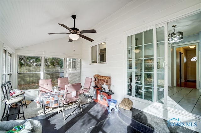 sunroom / solarium with ceiling fan and vaulted ceiling