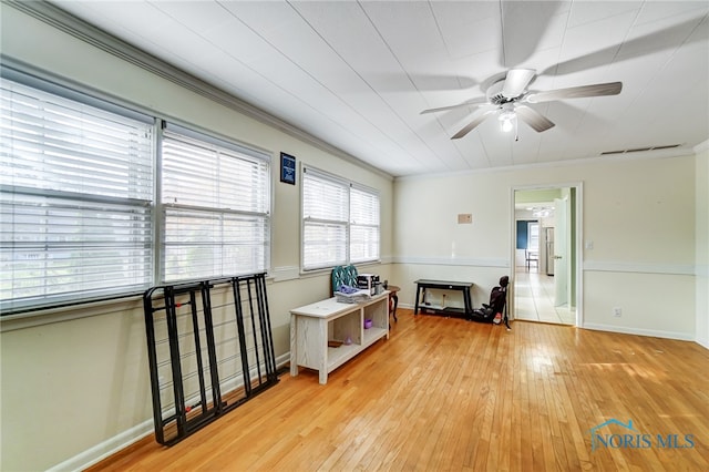 miscellaneous room with ornamental molding, ceiling fan, and light hardwood / wood-style floors