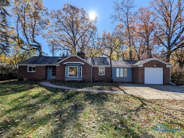 ranch-style home with a garage and a front yard