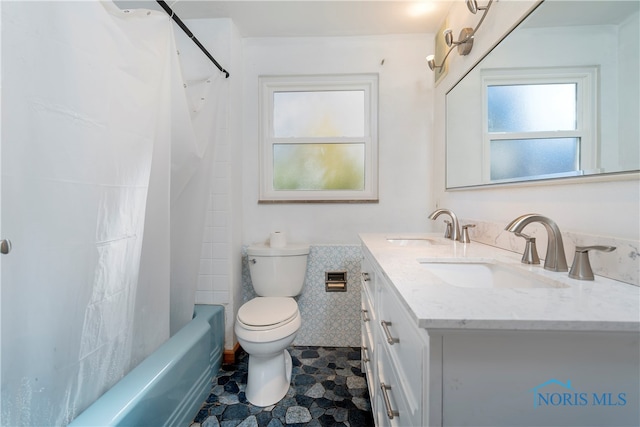 full bathroom featuring tile patterned floors, toilet, tile walls, vanity, and shower / tub combo with curtain