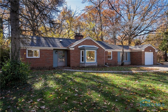 ranch-style home featuring a front lawn and a garage