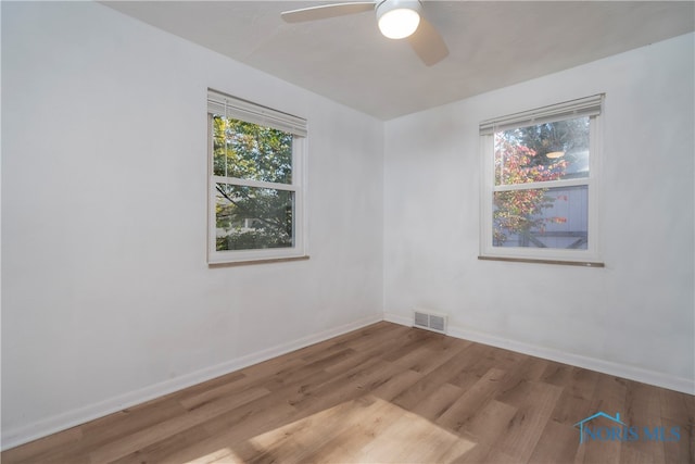 unfurnished room featuring ceiling fan and light wood-type flooring