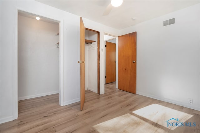 unfurnished bedroom with ceiling fan and light hardwood / wood-style flooring