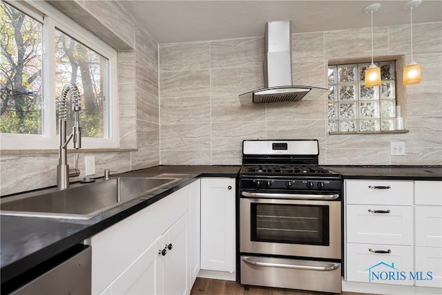 kitchen with white cabinets, gas range, sink, dark hardwood / wood-style floors, and extractor fan