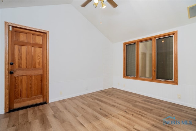 empty room featuring light hardwood / wood-style floors, ceiling fan, and vaulted ceiling