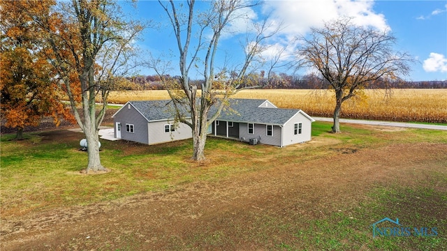 exterior space featuring a rural view and a front lawn