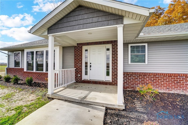 view of exterior entry with covered porch