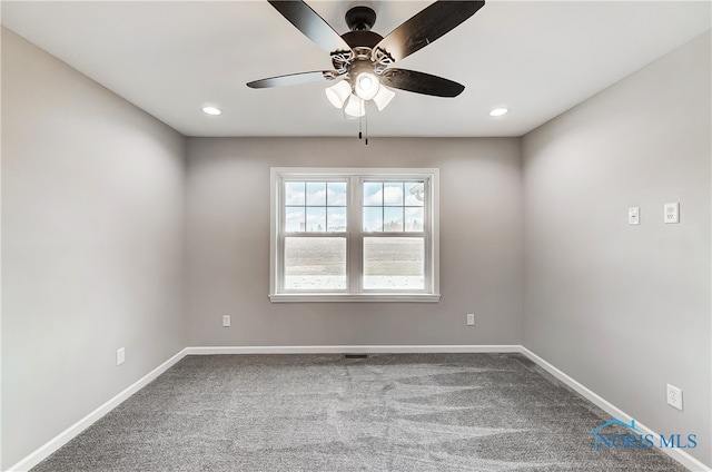 spare room featuring ceiling fan and carpet floors