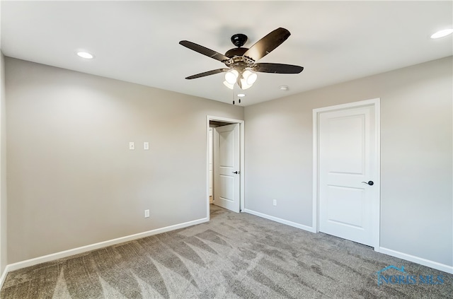 unfurnished bedroom featuring light colored carpet and ceiling fan