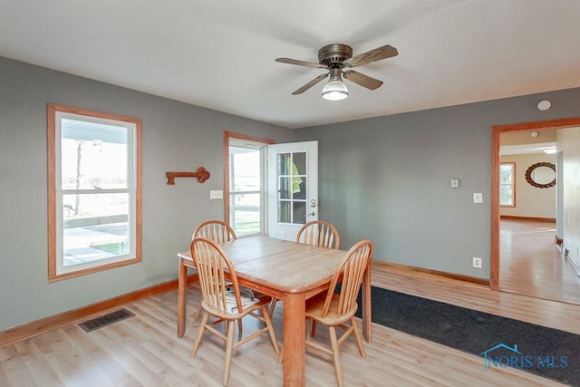 dining space featuring ceiling fan and light hardwood / wood-style flooring