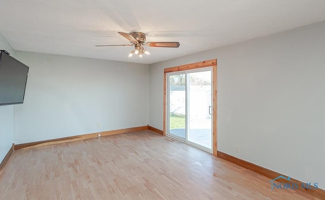 spare room with ceiling fan and light wood-type flooring