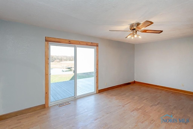 unfurnished room featuring ceiling fan and light wood-type flooring