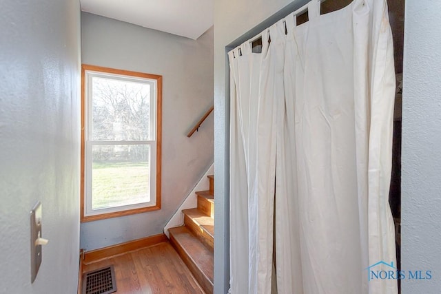 stairway featuring hardwood / wood-style flooring