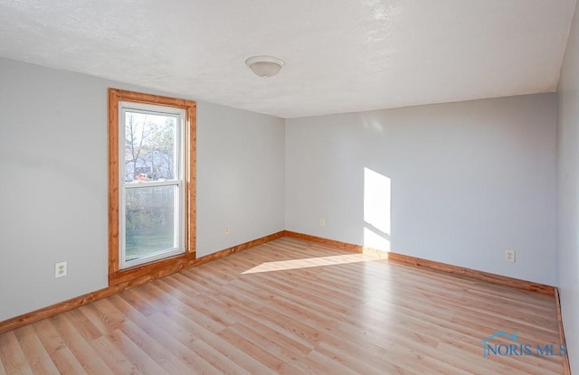 empty room with light hardwood / wood-style flooring