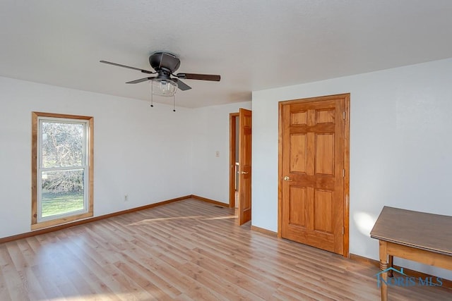 spare room featuring ceiling fan and light hardwood / wood-style floors