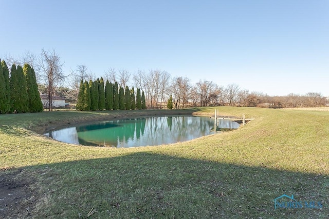 exterior space with a yard and a water view