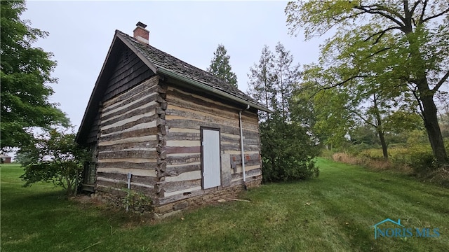 view of outbuilding with a lawn