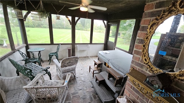 sunroom / solarium featuring ceiling fan