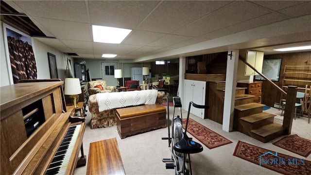 carpeted bedroom featuring a drop ceiling