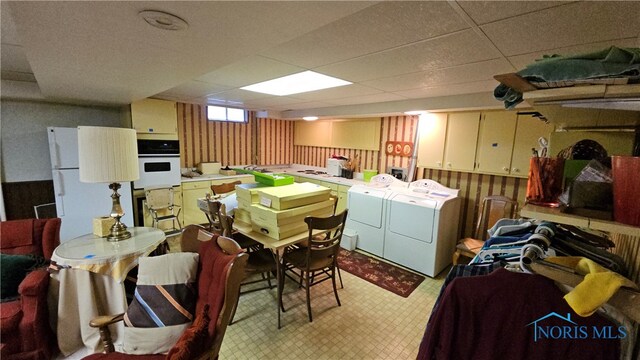 interior space with a paneled ceiling and separate washer and dryer